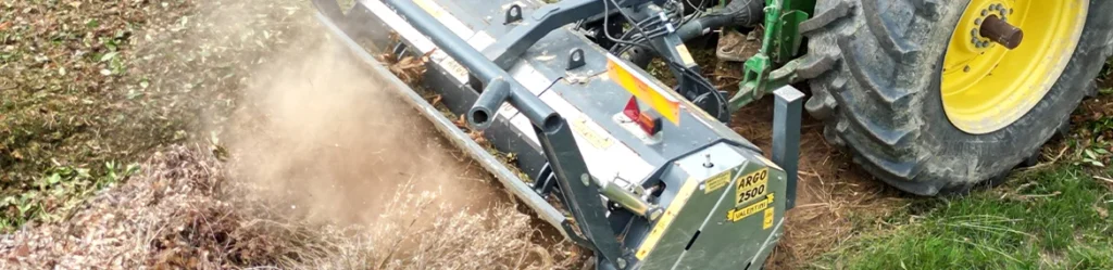 Stump grinder cutting a tree stump below ground level in a garden